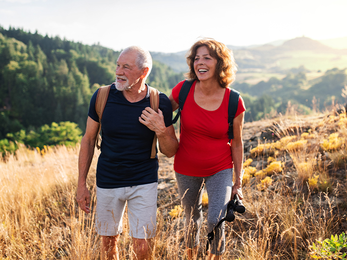 happy senior couple hiking and smiling retirement strategy freedom dream team california