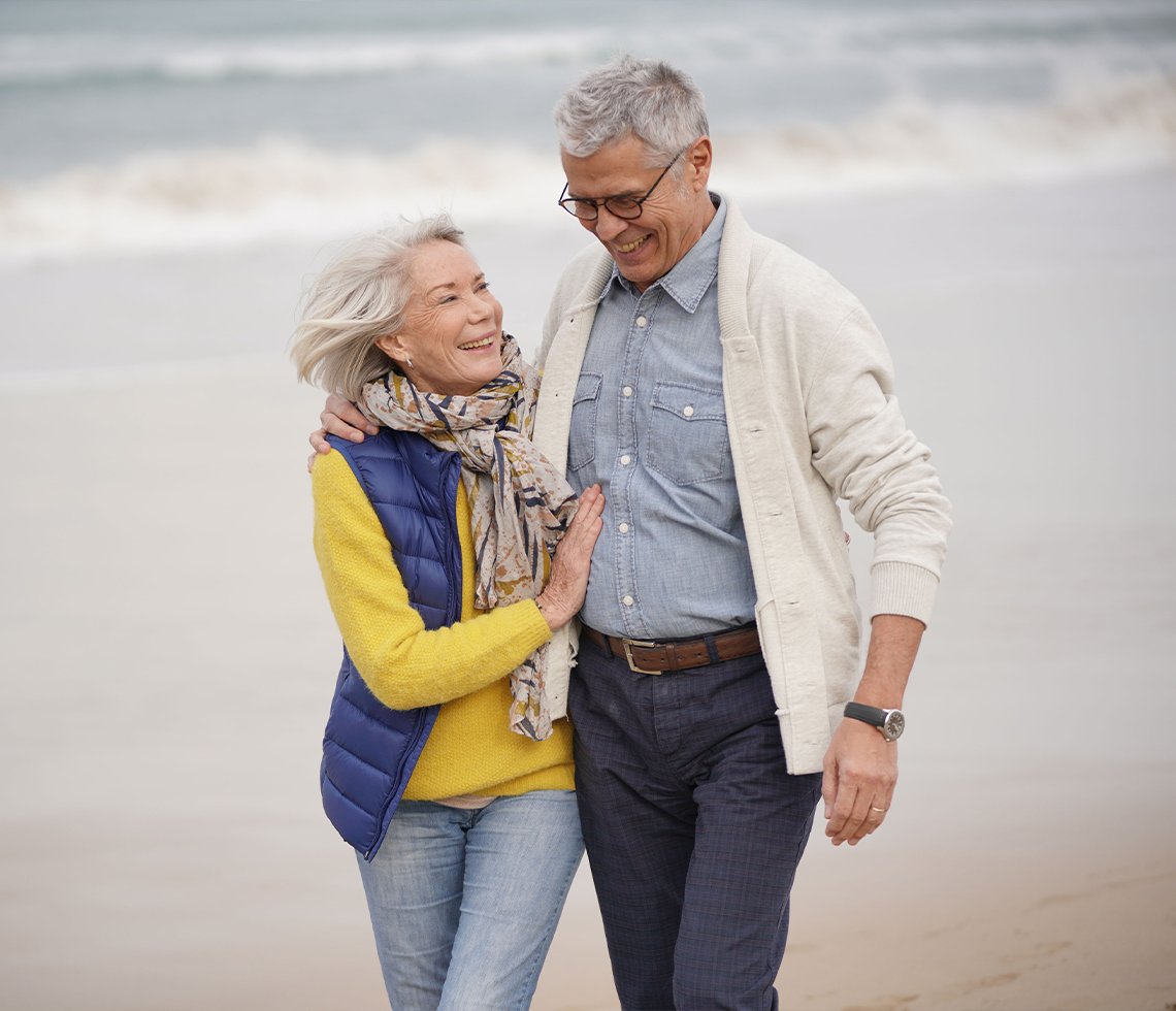 senior couple walking beach smiling retirement taxes freedom dream team california